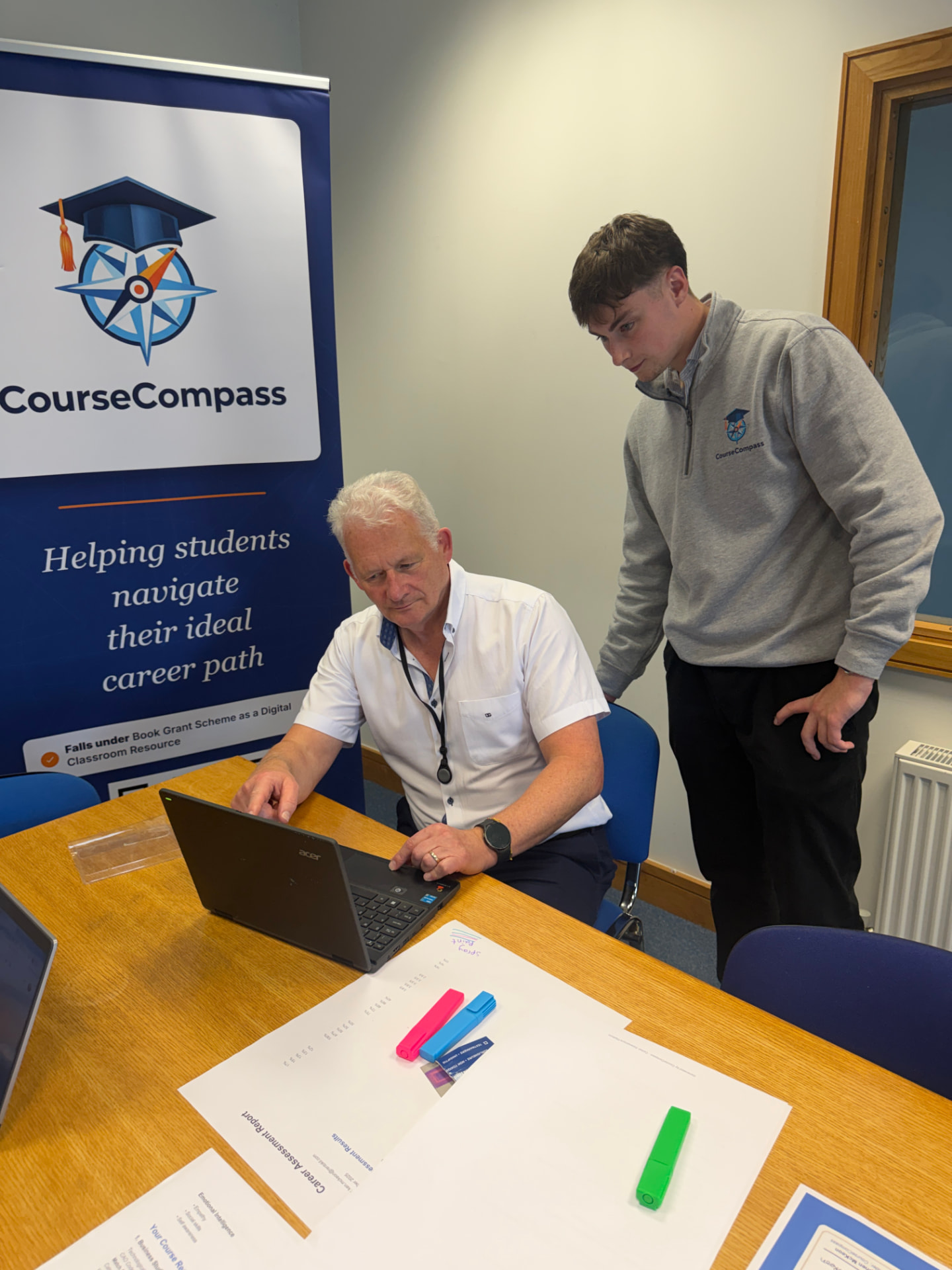 A CourseCompass team member walking a guidance counsellor through the platform on a laptop